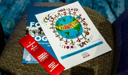 Printed copies of the 100th Anniversary pamphlet, ribbon, and new Strategic Plan on a chair at the CEC 2022 Convention & Expo in Orlando