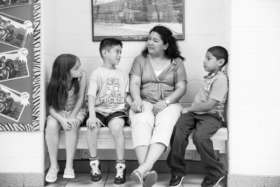 Teacher sitting with students