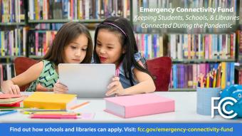 2 young female students doing homework in the library